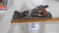 Full length view of Stanley Bailey No 5 wood plane alongside a ruler showing length measurement approximately 14 inches.