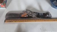 Side profile of the plane alongside ruler showing overall length.