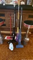 All five items together, showing standing Bissell Magic Vacs, mop, duster, and small handheld vacuum.