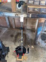 Full view of Scotty outrigger fishing reel mounted on a telescoping metal pole with adjustable brackets.