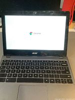 Front view of Acer Chromebook laptop turned on showing Chrome OS screen.