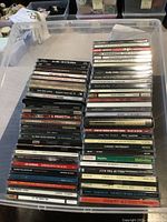 Photo shows stacks of CD jewel cases including visible titles such as B.B. King Live at the Apollo, Pink Floyd The Wall, The White Stripes Elephant.