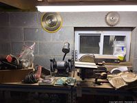 Craftsman belt and disc sander alongside Central Machinery bench grinder and assorted tools on workbench
