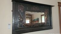 Full front view of the rectangular mirror with hammered copper frame and floral embossing
