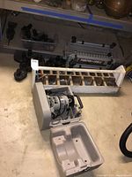 Porter Cable dovetail jig, hand tool organizer with nails and screws, and Porter Cable router kit with case on floor.