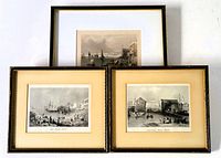 Three framed prints arranged: two smaller matching framed black and white prints with mattes and a larger frame with hand-coloured engraving behind.