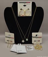 Full view of the lot on black display stand with two necklaces with opal pendants, hoop earrings, chain earrings, loose chain, and packaging cards with Danecraft Primavera Italy branding and Kohl's tags.