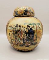 Front and side view of the small vintage Japanese Satsuma lidded ginger pot showing detailed hand-painted figures and floral design.