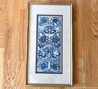 Full view of rectangular framed embroidered textile mounted under glass with triple matting and bamboo-motif gold wooden frame.