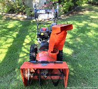 Front view showing auger housing, impeller and tires