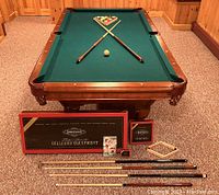 Wide shot of pool table and all included accessories arranged in front