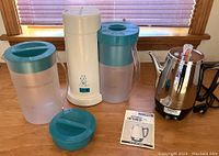 GE 10-cup percolator with manual and parts alongside Mr. Coffee Iced Tea Pot with two pitchers and lid