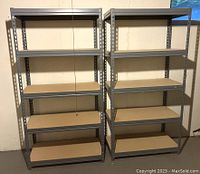 Two metal shelving units side by side against wall