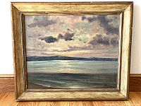 Full view of framed oil painting depicting seascape at sunset
