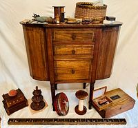 Full frontal view of sewing cabinet with accessories on and around it