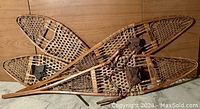 Both pairs of wooden framed snowshoes, men's Walter Frederick Tubbs and women's Northland, showing size and form.