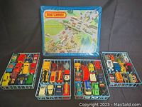 The complete set of 48 Matchbox vehicles organized in four sectioned trays displayed alongside the original carrying case with graphic lid.