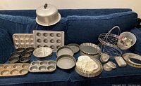 Photo of vintage baking supplies displayed on blue couch