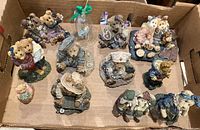 Top-down photo showing all 10 bear figurines arranged in a box, depicting the variety of themed characters and outfits.