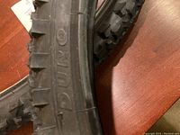 Close-up photo showing the sidewall of the bike tire with 'DURO' embossed branding and visible tread pattern