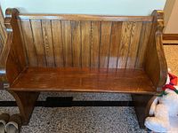 Front view of wooden church pew bench with beadboard back and flat seat