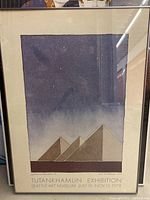 Full view of framed print showing pyramids under starry sky and exhibition text