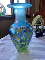 Full view of vase on table with background window