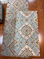 Photo showing the two cushioned floor runners laid overlapping on a hardwood floor, displaying the full pattern and texture.