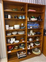 Front view showing full height and width of teak veneer shelving unit with six open shelves