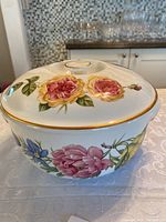 Covered casserole dish with lid, showing floral patterns and gold accent trim