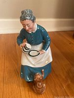 Front view of Royal Doulton porcelain figurine of an elderly woman with cat.