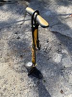 Full view of BV bike pump showing ergonomic handle and sturdy base on gravel