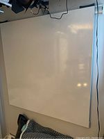 Medium or large whiteboard panel mounted on track showing surface and frame