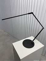Full view of lamp showing extended adjustable arm and LED light bar