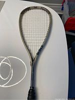 Full view of Prince Triple Threat RIP squash racket showing frame, strings, and grip condition.