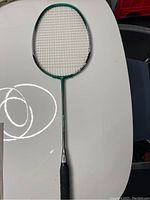 Full length view of the green and black badminton racket placed on a table