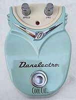 Front view of Danelectro Cool Cat pedal showing Speed and Chill knobs, signature chrome D logo, footswitch, and light blue enclosure.