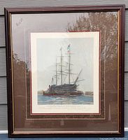 Framed lithograph print of ship titled 'The Last Journey of Victory' with triple matting and wooden frame