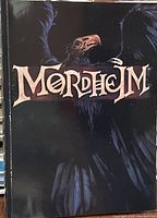 Front cover of the Mordheim rulebook showing raven artwork and title