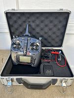 Spektrum DX6e transmitter, charger, and foam-lined case with open lid showing all items together