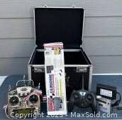 Entire lot showing the 2 transmitters, aircraft balancer, receiver, charger, and travel case.