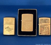 Front view of three solid brass Zippos: USS Missouri BB 63, USS Iowa BB 61 in retro box, USS Laboon DDG 58