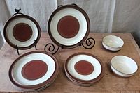 Full set of Denby Potter's Wheel stoneware pieces showing 4 dinner plates, 4 salad plates, and 2 bowls arranged on tabletop.