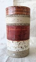 Front view of Denby Potter's Wheel vase showing the tan, rust, and speckled cream horizontal bands, along with beaded textured ring detailing.