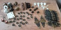 Overview of entire collection showing door knobs, locks, drawer pulls, and backplates on wooden surface