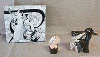 Two Guernica-inspired salt and pepper shakers displayed with original box showing Picasso-like artwork in black and white.