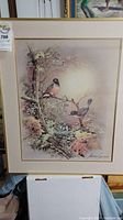 Full view of framed signed art print showing two robins perched on tree branches with blossoms, measuring 29.25x24 inches.