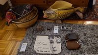 Overview of all lot items arranged on floor: fish bowl, baskets, pouches, seals, inkstone box and cloths