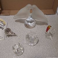 Full view of five crystal and glass bird figurines showing size and details.