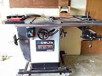Front view of Delta Unisaw table saw on wheeled stand